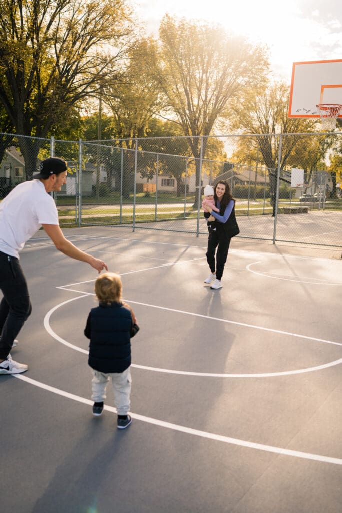 winnipeg family photographer at a basketball court capturing a family lifestyle session