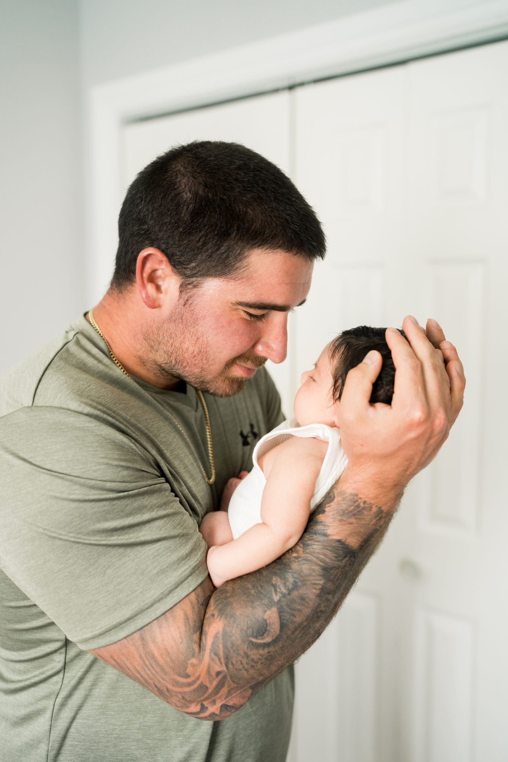 winnipeg newborn photographer captures dad in nursery with newborn baby girl