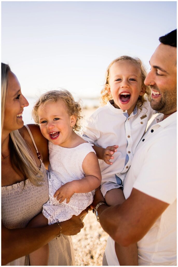 Winnipeg family photoshoot at Matlock Beach in the summer with beautiful morning light running around with their son and daughter.