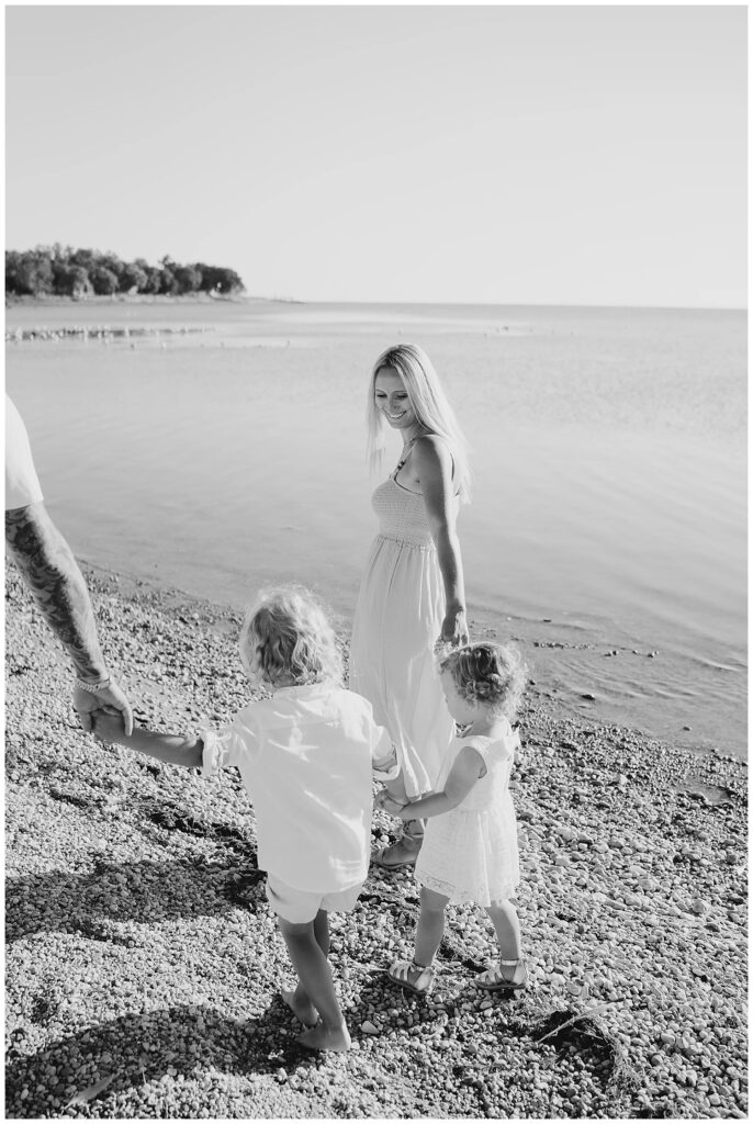 Winnipeg family photoshoot at Matlock Beach in the summer with beautiful morning light running around with their son and daughter.