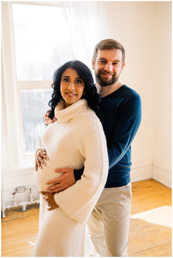 Winnipeg maternity photographer captures lifestyle maternity session in studio with baby number 3 on the way in downtown winnipeg at my studio.