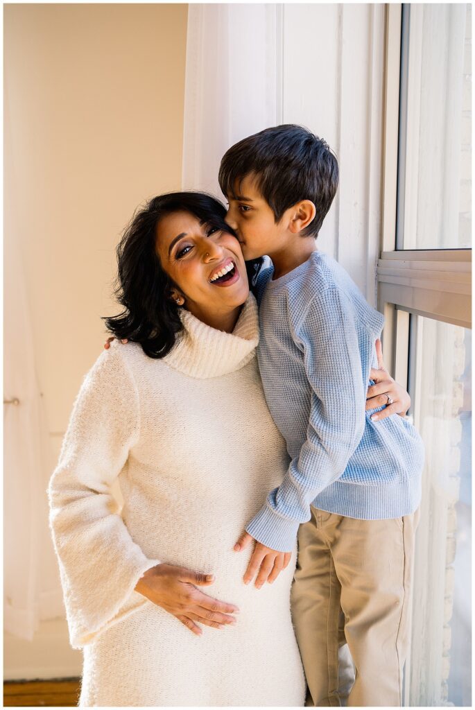 Winnipeg maternity photographer captures lifestyle maternity session in studio with baby number 3 on the way in downtown winnipeg at my studio.