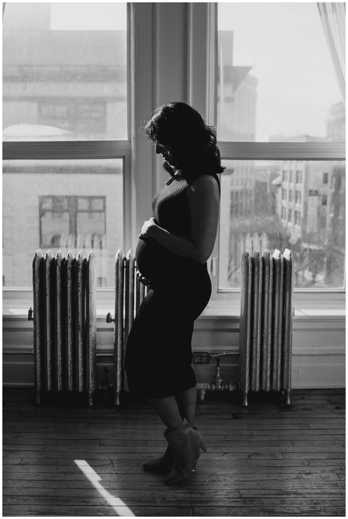 Winnipeg maternity photographer captures lifestyle maternity session in studio with baby number 3 on the way in downtown winnipeg at my studio.