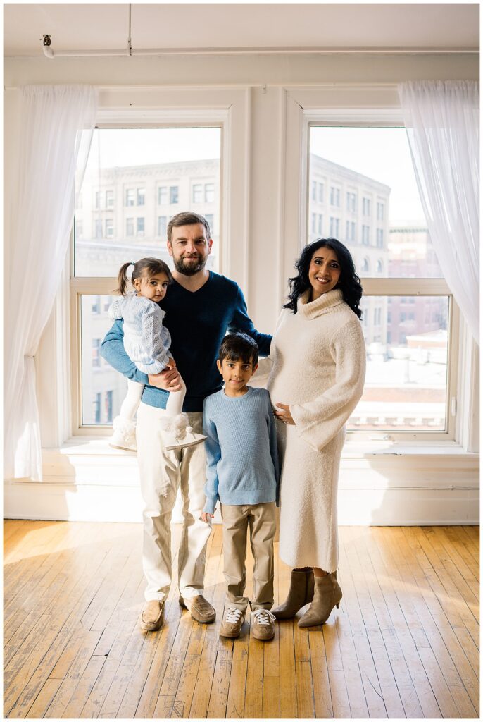 Winnipeg maternity photographer captures lifestyle maternity session in studio with baby number 3 on the way in downtown winnipeg at my studio.