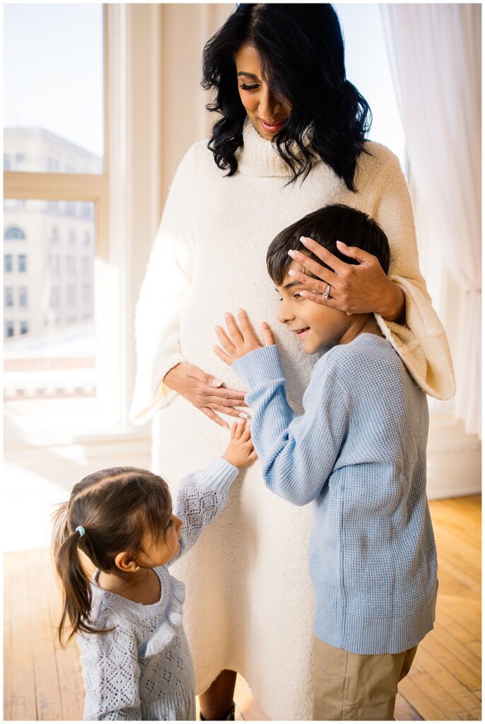 Winnipeg maternity photographer captures lifestyle maternity session in studio with baby number 3 on the way in downtown winnipeg at my studio.