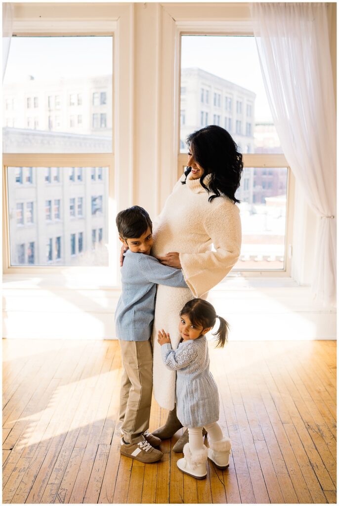 Winnipeg maternity photographer captures lifestyle maternity session in studio with baby number 3 on the way in downtown winnipeg at my studio.