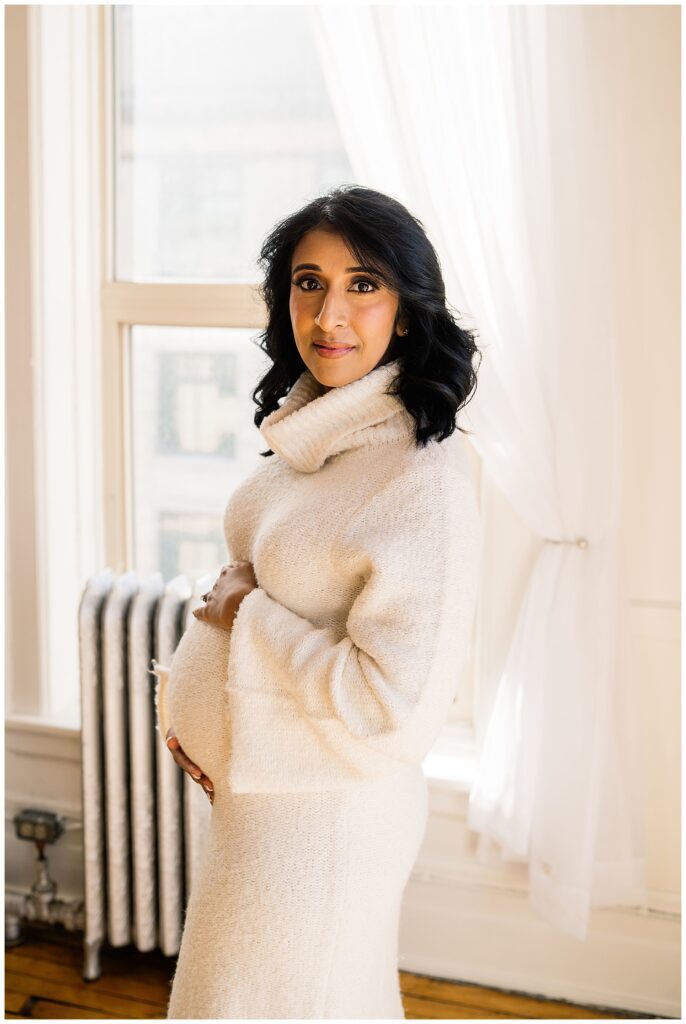 Winnipeg maternity photographer captures lifestyle maternity session in studio with baby number 3 on the way in downtown winnipeg at my studio.