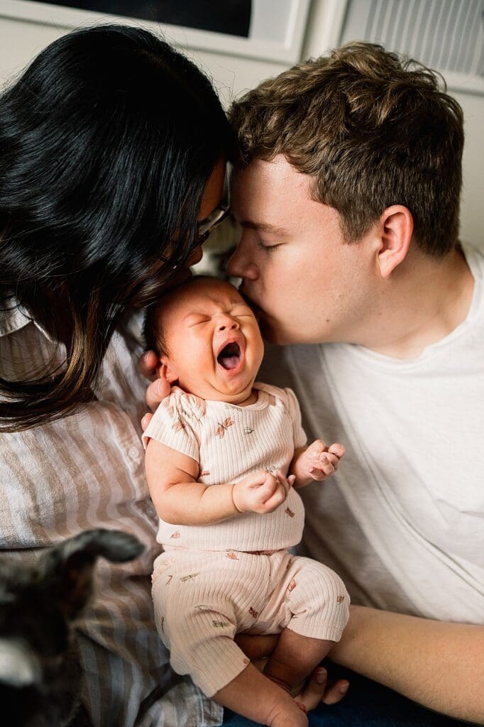 in home newborn photoshoot with a brand new baby with their cute dogs in their home