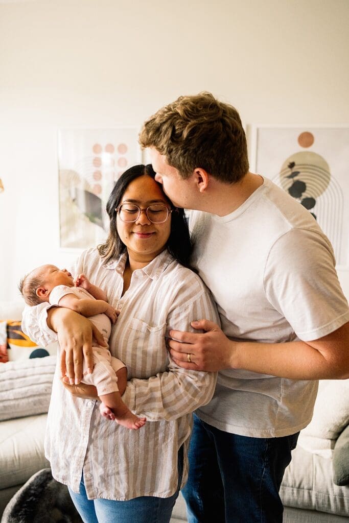 in home newborn photoshoot with a brand new baby with their cute dogs in their home