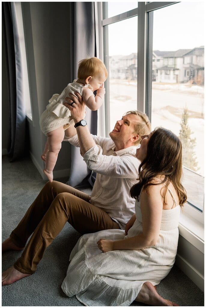 In home family session Winnipeg with parents and baby girl